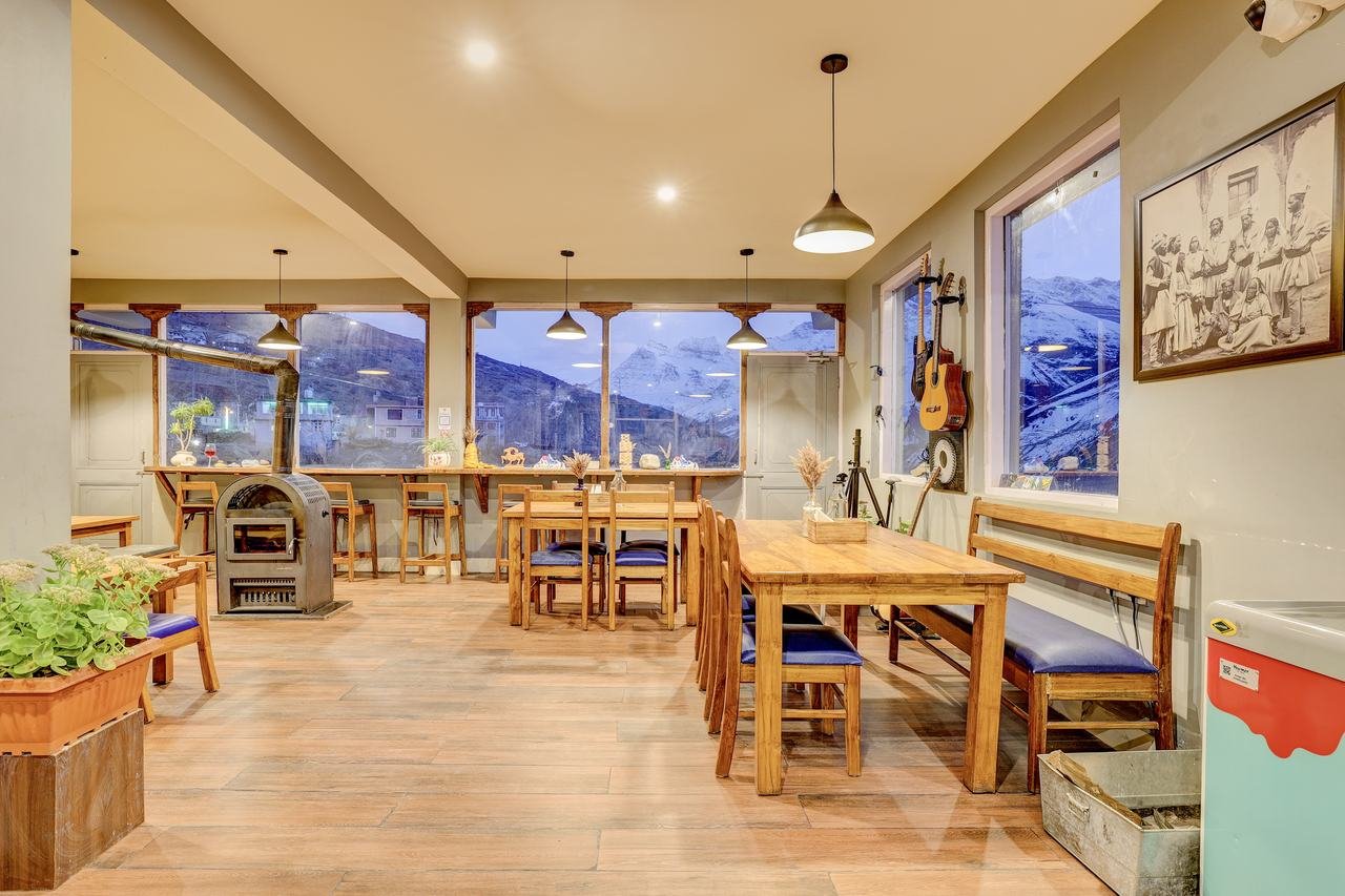 Oven Xpress dining area with wood stove at Utpala House